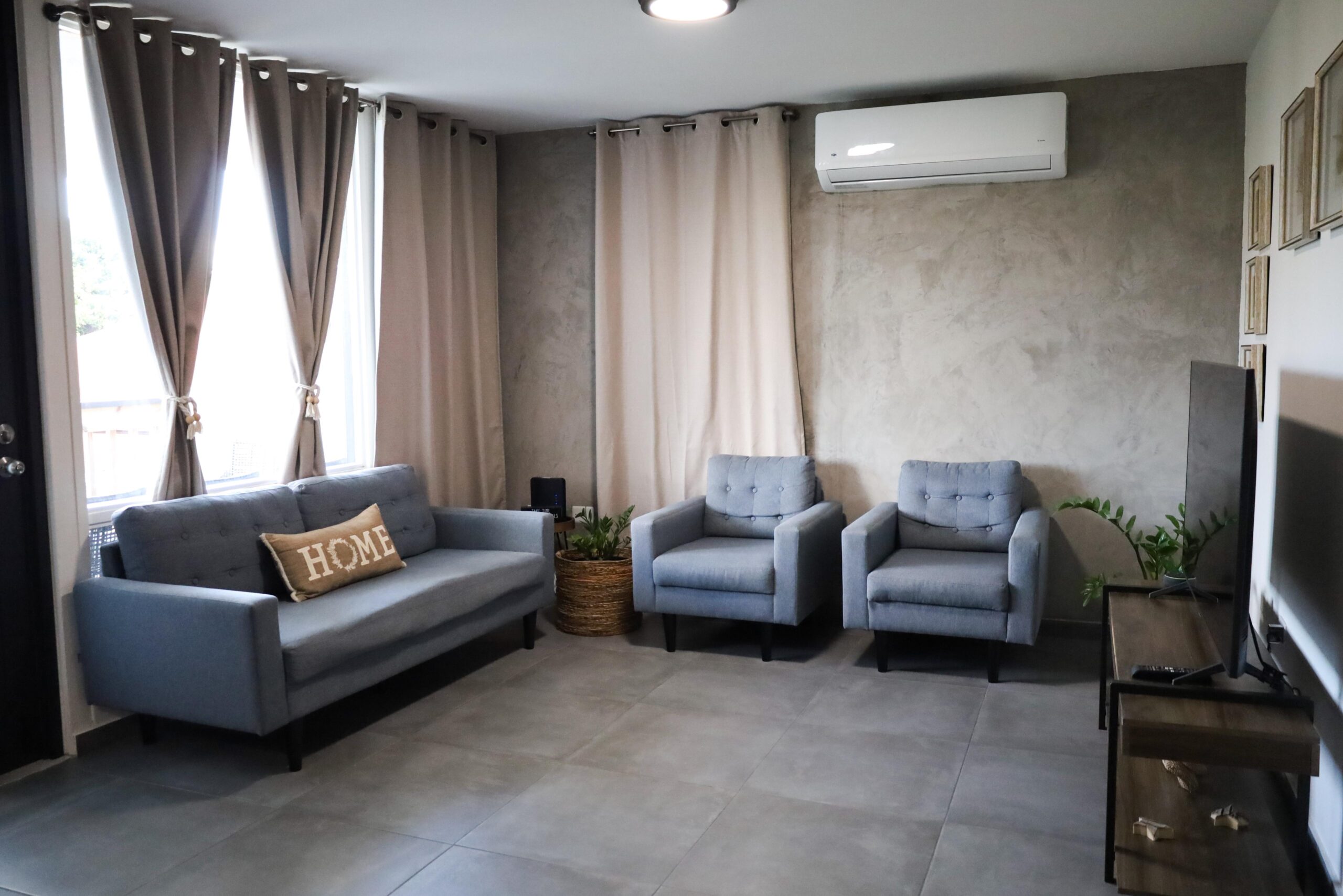 Modern living room at VillaMar Fajardo with smart TV and air conditioning
